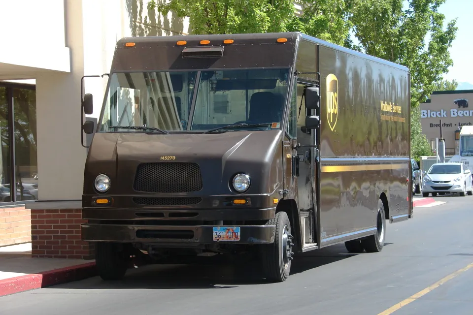 UPS delivery truck parked by urban sidewalk